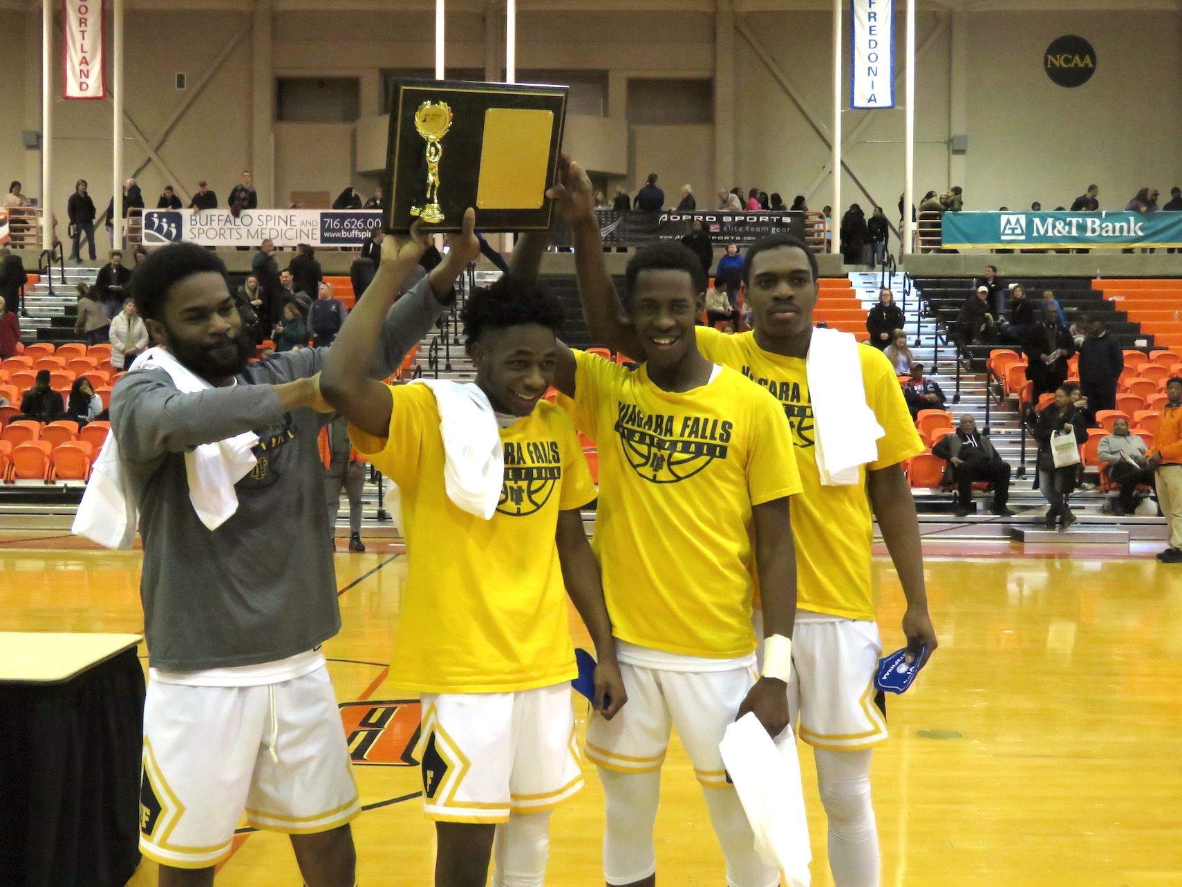 The four seniors for the Wolverines receive their Section VI championship plaque. From left: Marquise Miller, Tazaun Rose, Quran Dubois and Syquan Ralands. (Photo by David Yarger)